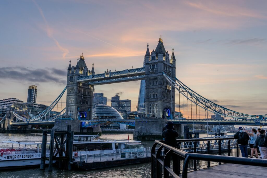 Stunning sunset scene of London's Tower Bridge over the River Thames with urban skyline.