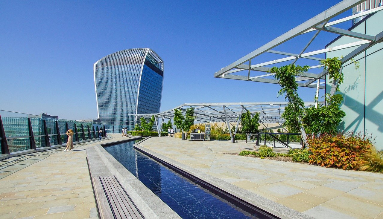 London rooftop event space hosting a phygital corporate gathering, blending physical networking with digital insights and panoramic city views.